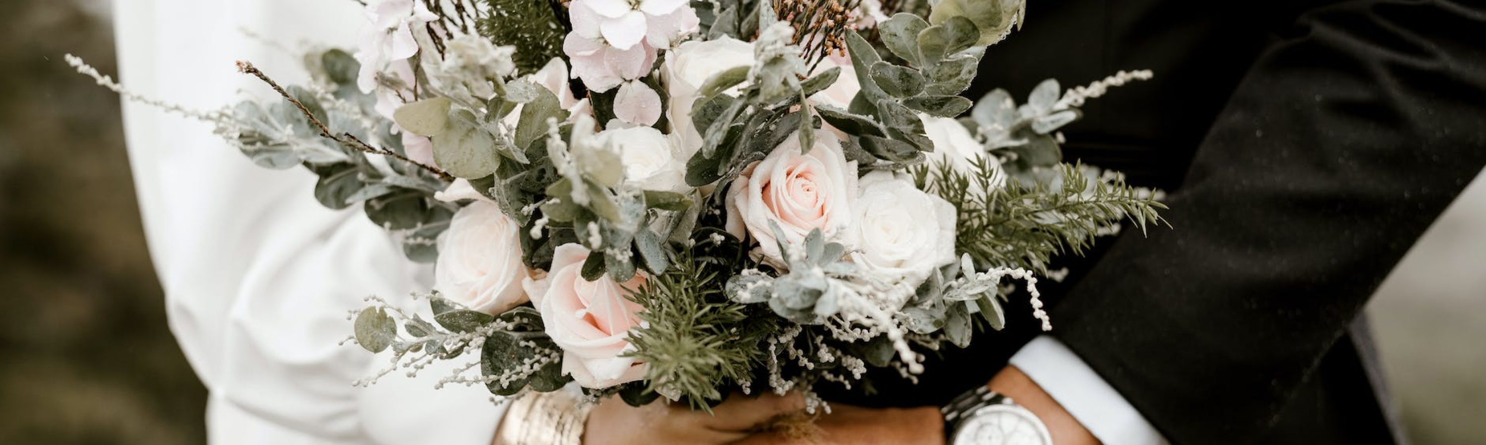 bridge and groom standing while holding flower bouquet